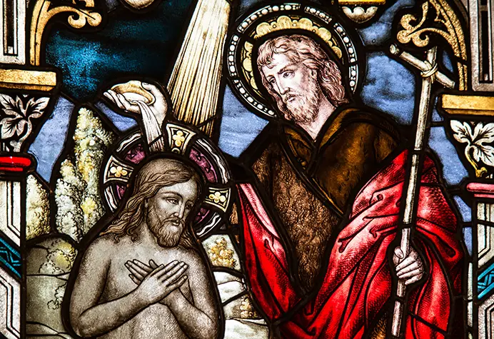 A stained glass window depicting jesus and the risen christ.
