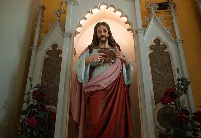 A statue of jesus holding the heart of christ.