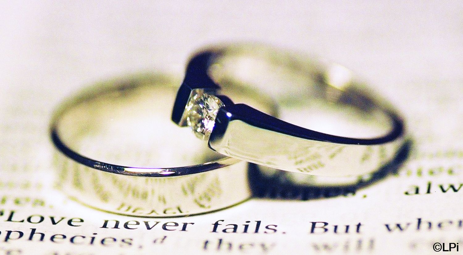 A close up of two wedding rings on top of a book