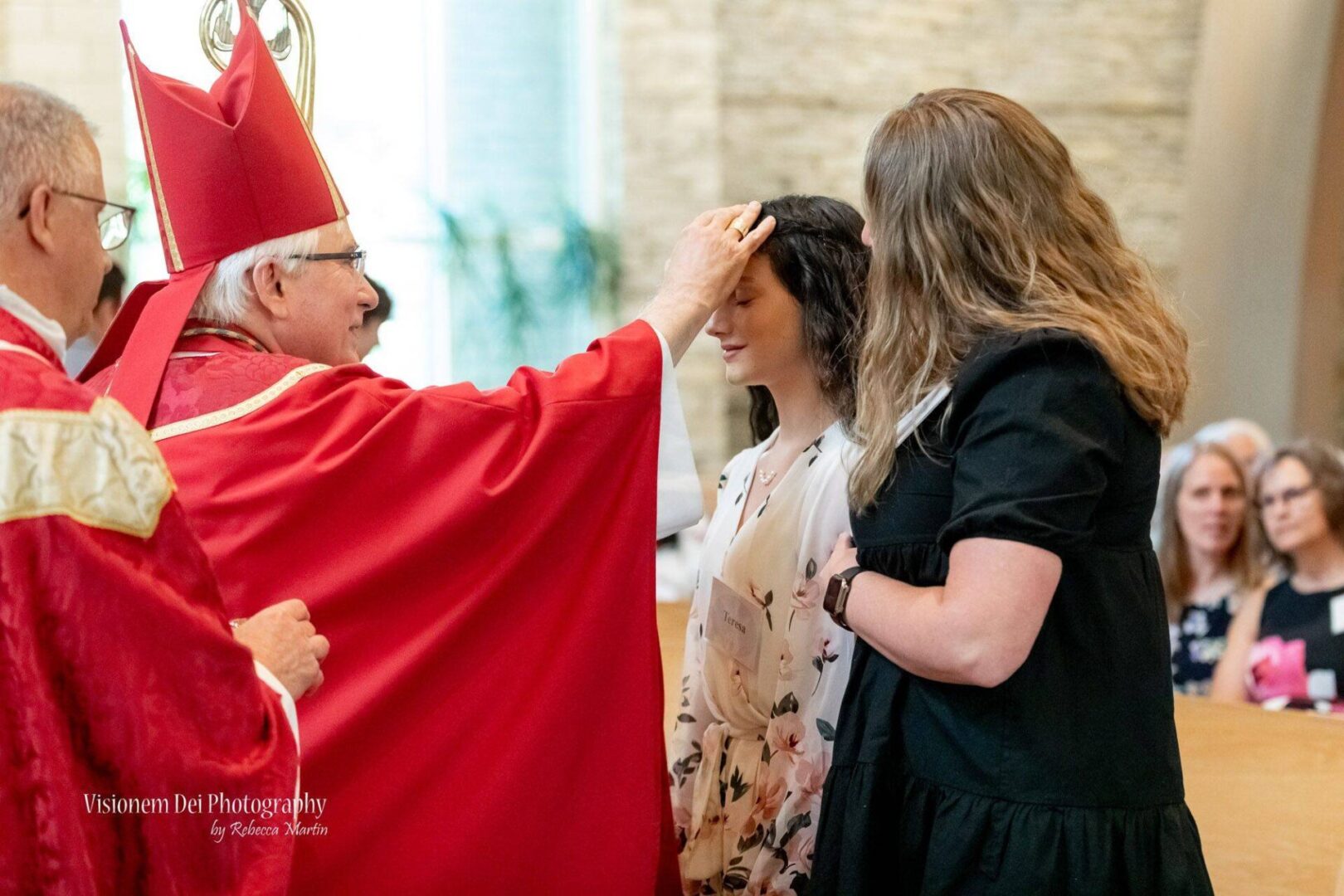 A woman is getting her hair combed by an archbishop.