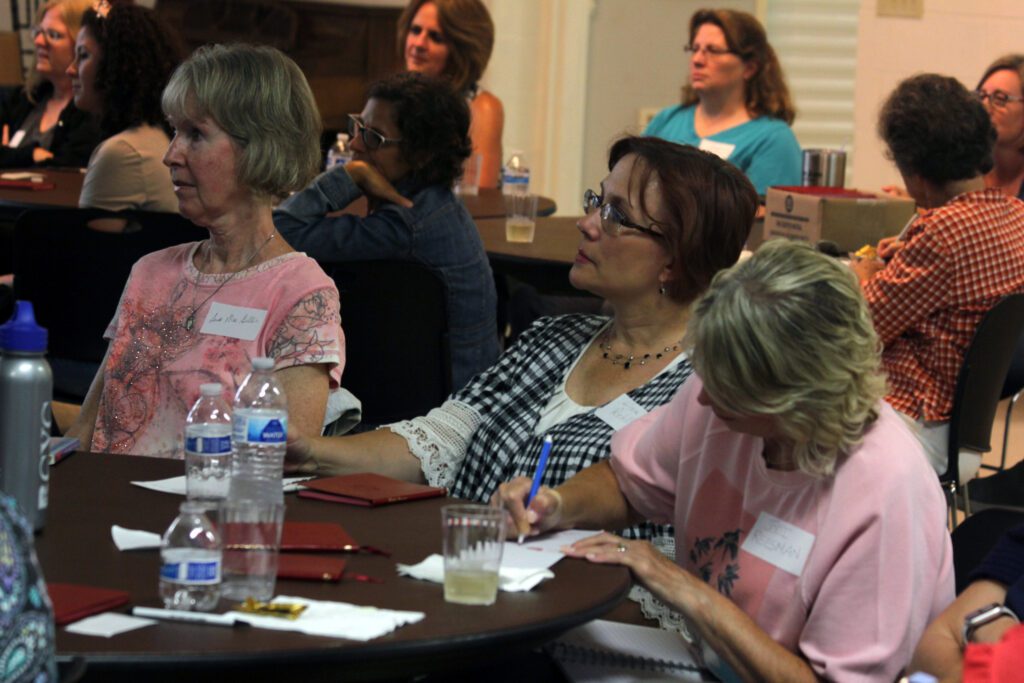 Attendees listening attentively at a seminar or workshop.