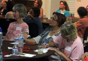 Attendees listening attentively at a seminar or workshop.